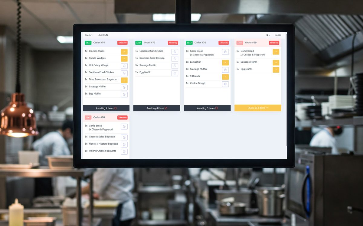 menyu kitchen display screen showing live order tickets above the pass